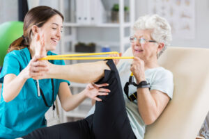 Milton Keynes physiotherapist assisting a patient with therapy exercises