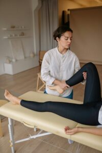 Physiotherapist providing hands-on treatment for back pain recovery in Milton Keynes clinic